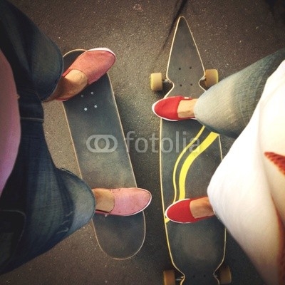 a boy's and girl's legs on boards