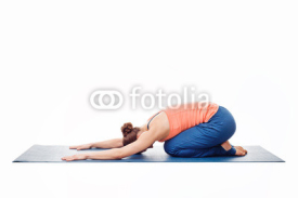 Woman doing Ashtanga Vinyasa Yoga relaxation asana Balasana chil