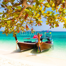 Wooden boats on a tropical beach.