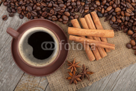 Obrazy i plakaty Coffee cup and spices on wooden table