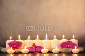 Fototapety Row of aromatic candles and orchid petals.