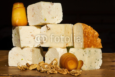 Cheese collection with walnuts on a wooden table