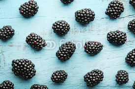 Naklejki Ripe and sweet blackberries on blue wooden table