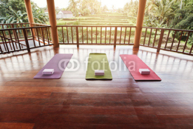 Empty yoga studio with colorful mat