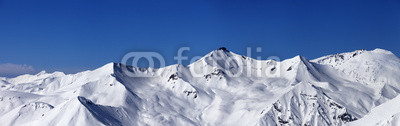 Panoramic view on off-piste slopes and blue sky at nice day