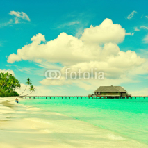 tropical island beach with turqiuse water and blue sky
