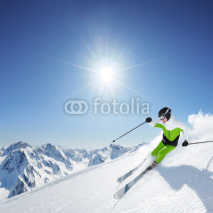 Obrazy i plakaty Skier in mountains, prepared piste and sunny day