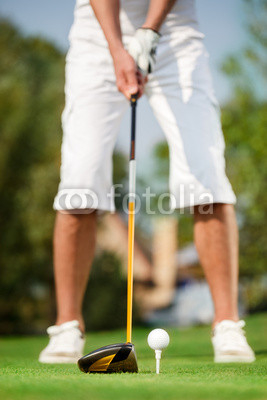close up shot of golfer ready to tee off