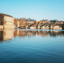 Prague, Charles bridge reflected in Vltava river in the morning