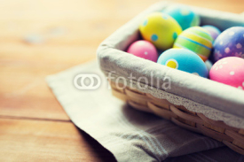 close up of colored easter eggs in basket