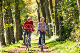 Naklejki Seniors exercising with bicycle