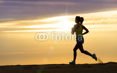 Athlete running at sunset on beach