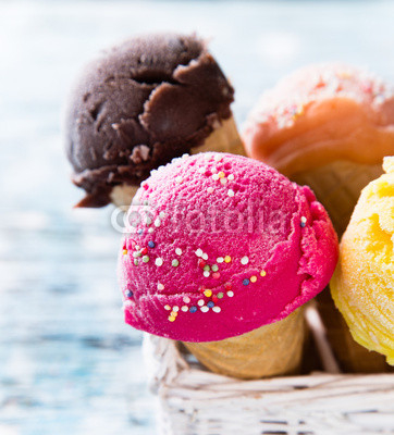 Ice cream scoops on wooden table.