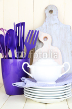 Fototapety Plastic kitchen utensils in cup on wooden table