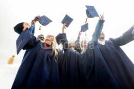happy students throwing mortar boards up