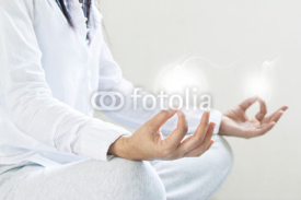 Fototapety woman meditating of purity energy insight on gray background
