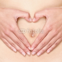Naklejki Pregnant woman pregnancy concept heart on stomach
