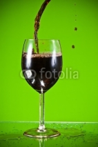 Naklejki Red wine poured into glass