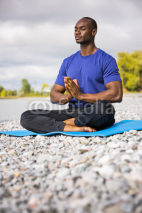 Naklejki young man exercising yoga