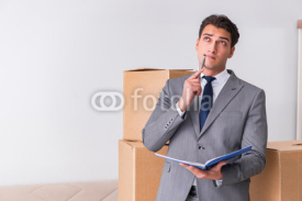 Man signing for the delivery of boxes