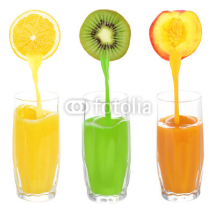 Naklejki Juice pouring from fruits into glass, isolated on white