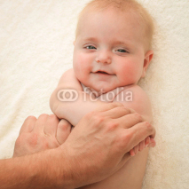 masseur doing exercise for hands little baby