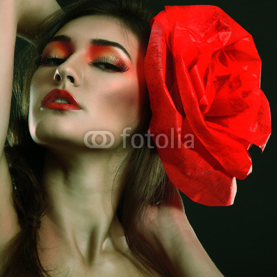 portrait of fashion glamour girl with red flower in her hair