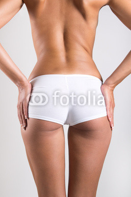 Woman with perfect body checking cellulite