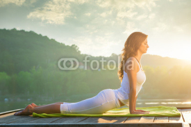 Naklejki Woman doing yoga on the lake - relaxing in nature