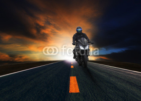 Naklejki young man riding motorcycle on asphalt road