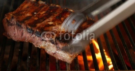 Ribs on the grill with flames