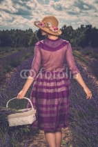 Naklejki Woman in purple dress and hat with basket 