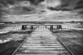 Fototapety Old wooden jetty during storm on the sea. Dramatic sky