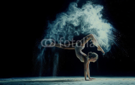 Naklejki Graceful woman dancing in cloud of dust