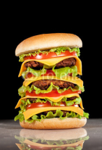 Naklejki Tasty and appetizing hamburger on a dark