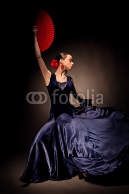 young woman dancing flamenco on black