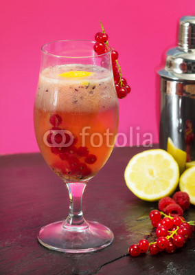 fruit cocktail with mixer over pink background