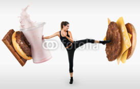 Naklejki Fit young woman fighting off fast food