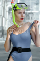 Fototapety Girl demonstrates a diving mask with snorkel