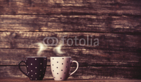Fototapety Two tea or coffee cup on wooden table.