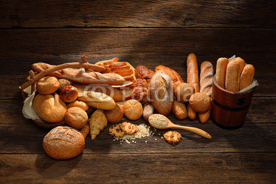 Variety of bread on old wooden background.