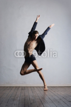 Fototapety Young and fit modern dancer performing a move