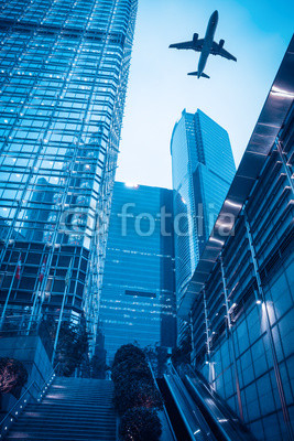 modern building with airplane at dusk