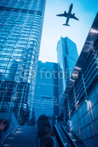 Fototapety modern building with airplane at dusk