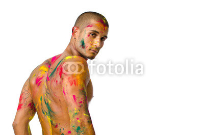 Handsome young man with skin painted with colors