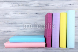 Naklejki color books on grey wooden background