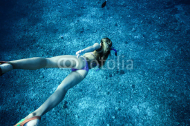 Naklejki An amazing woman with a beautiful ass in a bikini dives to the ocean floor. Views ass under water