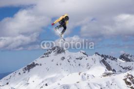 Naklejki Snowboard rider jumping on mountains. Extreme freeride sport.