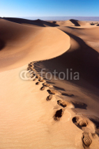 Obrazy i plakaty Human footprints on dunes of Erg Chigaga desert