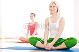 Naklejki Two yogas woman indoors
